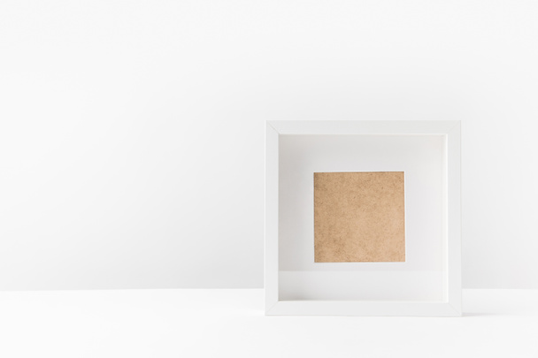close-up view of empty white photo frame on white   - Фото, изображение