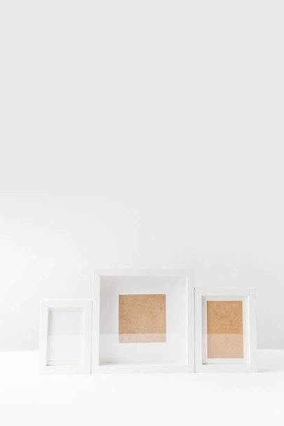 various empty white photo frames on white   - Valokuva, kuva