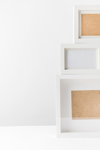 close-up view of empty white photo frames on white   - Photo, Image