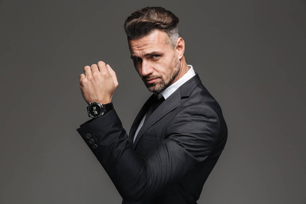 Portrait of handsome rich man 30s in black suit posing on camera - Foto, Imagem