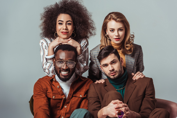 happy multiethnic retro styled friends looking at camera isolated on grey - Photo, Image