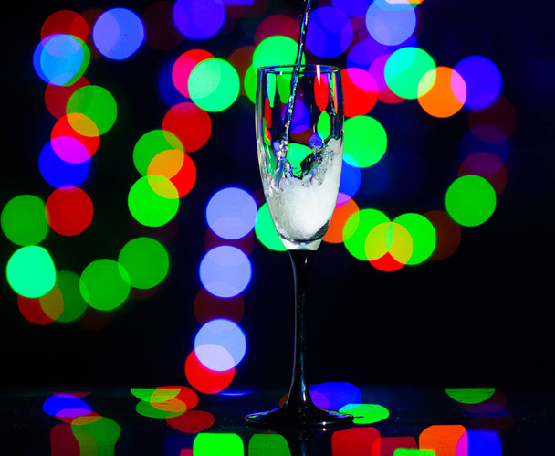 glass full of champagne against christmas lights. Holiday. Party - Фото, изображение