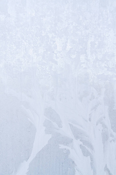 Winter frosty patterns on the frozen ice window - Photo, Image