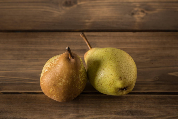 Delicious pears on a rustic wooden table. - Фото, зображення