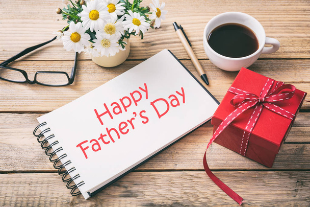 Red gift box and happy fathers' day on the notebook, office desk background - Foto, immagini