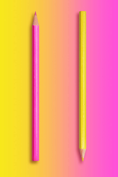 two pencils yellow and pink, gradient background from yellow to  - Photo, image