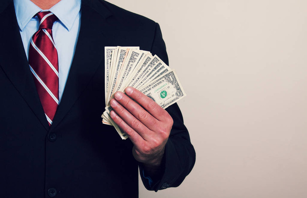 a businessman holding cash money - Фото, зображення