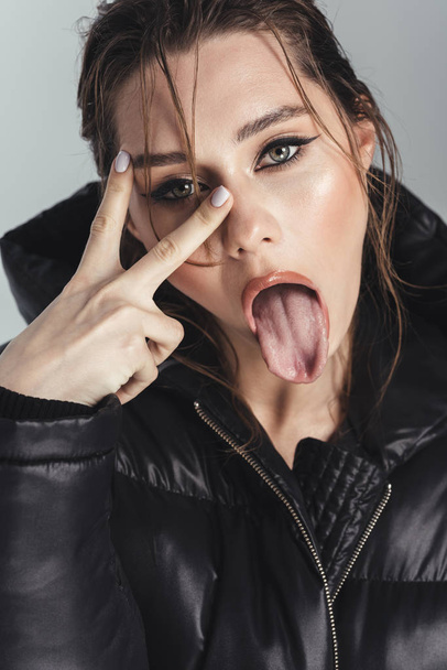 Sexy fashion young stylish woman showing tongue. - Foto, Imagem