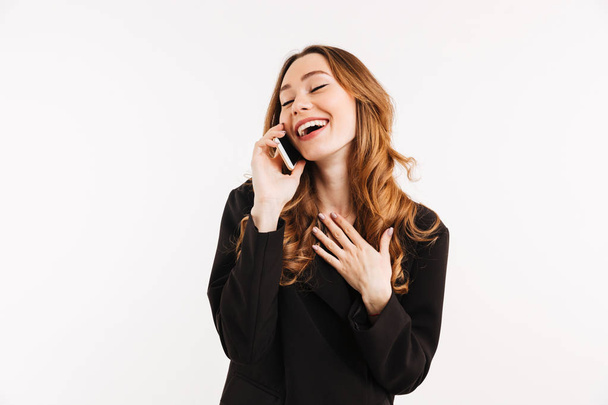 Smiling businesslike woman with long auburn hair in black talkin - Fotografie, Obrázek
