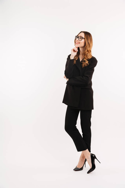 Full-length businesslike woman in total black outfit and eyeglas - Photo, image