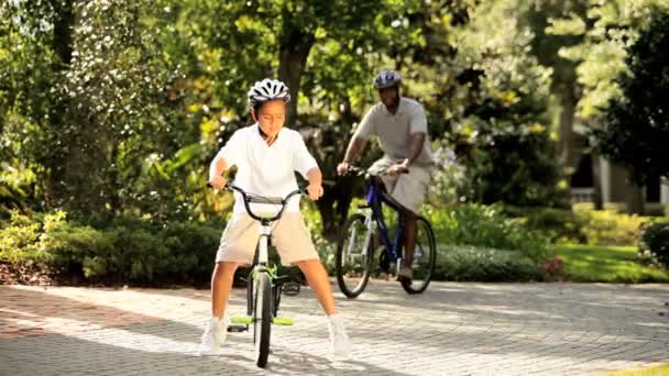 Ethnic family enjoying keeping fit cycling on vacation - Footage, Video