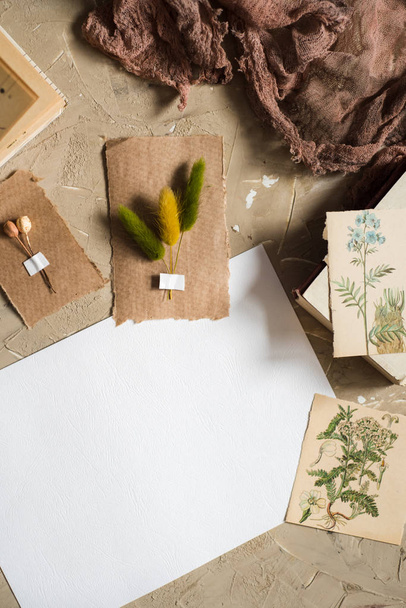 Flay lay, top view of the herbarium, dried lavender flowers, notebook, book for notes, pen and spring summer pictures on a concrete backgroundPostcard on kraft paper - Fotó, kép