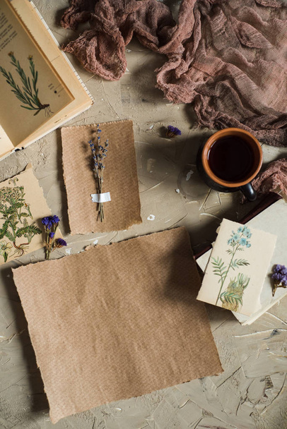 Flay lay, top view of the herbarium, dried lavender flowers, notebook, book for notes, pen and spring summer pictures on a concrete background. Postcard on paper - Foto, immagini