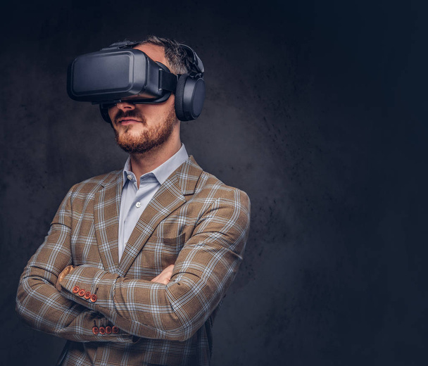 Studio portrait of a man wearing virtual reality glasses  - Фото, зображення