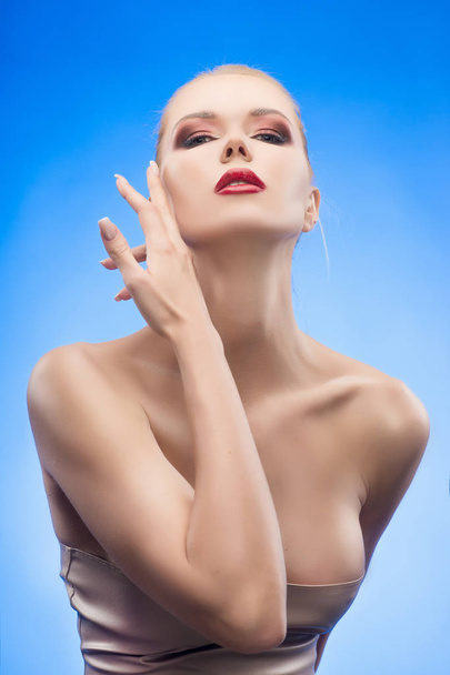 The beautiful blonde red lips girl touches by fingers her face a - Foto, Imagen