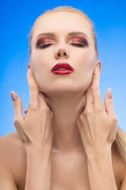 The beautiful blonde red lips girl touches by fingers her face a - Фото, изображение