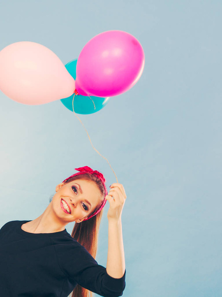 Smiling crazy girl having fun with balloons. - 写真・画像