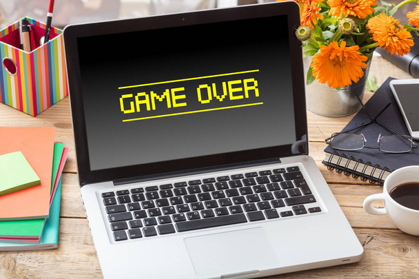 Game over on a laptop screen on an office desk - Foto, imagen