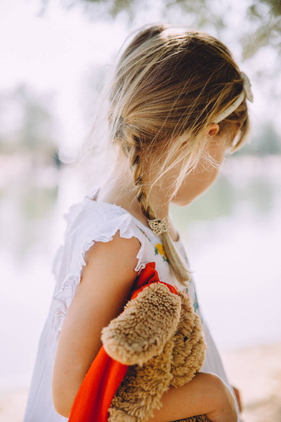 adorable little girl with toy teddy bear - Фото, зображення
