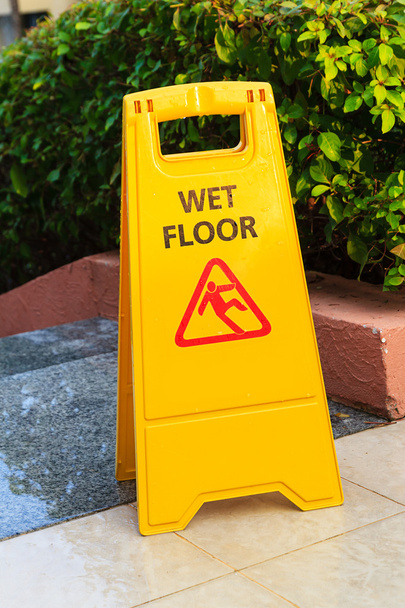 Sign with caution wet floor near the swimming pool - Photo, Image