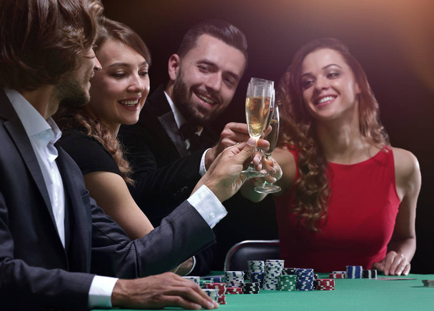 friends drinking and celebrating a gambling night - Foto, imagen
