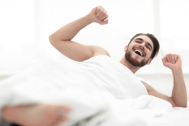 happy man waking up in the morning - Фото, изображение