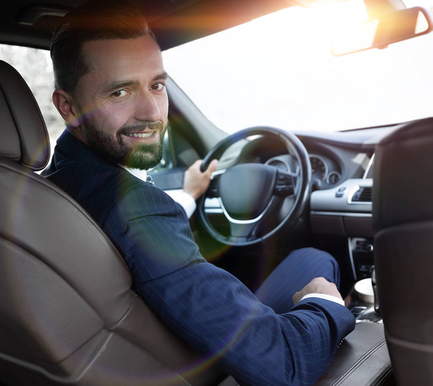 businessman sitting at the wheel of a prestigious car - Foto, Imagem