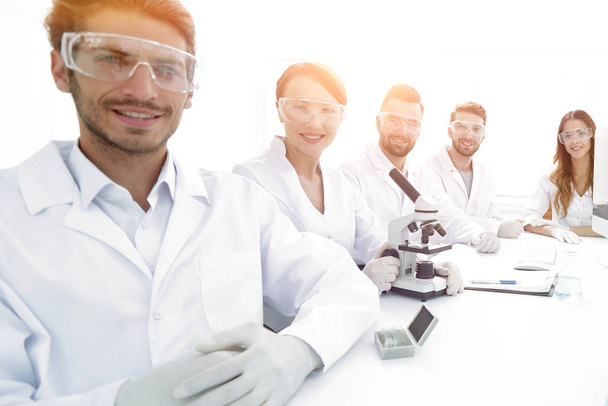 Male scientist and the team in the lab. - Фото, изображение