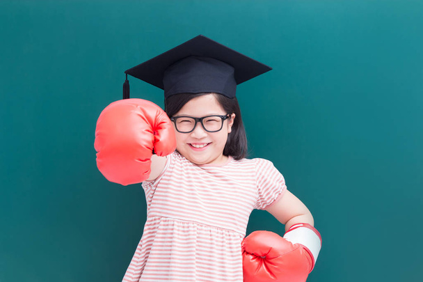 cute girl wearing  bachelor cap and  gloves on blank green chalkboard background - Photo, image