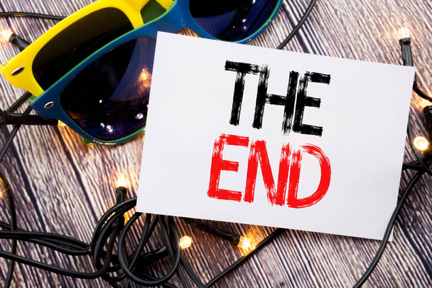 Writing text showing The End. Business concept for End Finish Close written on sticky note with copy space on old wood wooden background with sunglasses - Photo, Image
