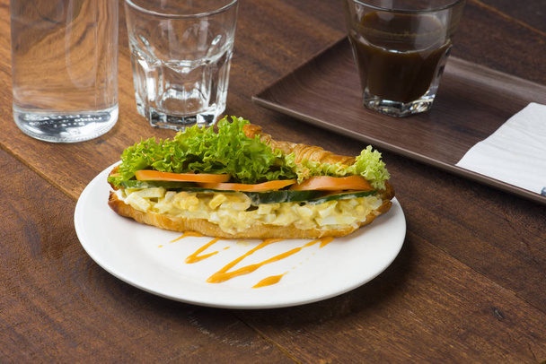 egg sandwich and coffee on white plate  - 写真・画像