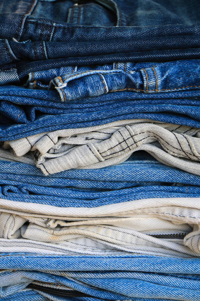 Group of blue denim jeans stack close up background - 写真・画像