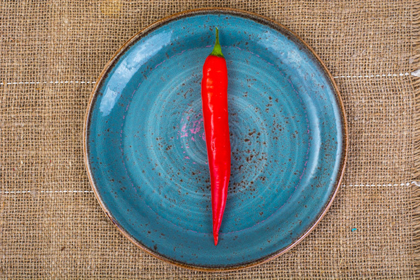 POD κόκκινης πιπεριάς σε ύφασμα φόντο - Φωτογραφία, εικόνα
