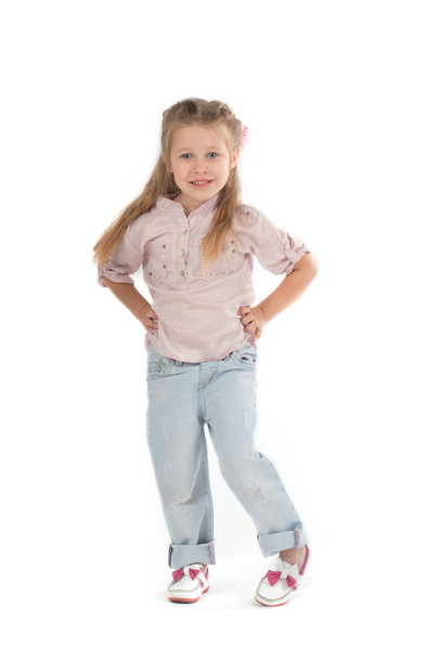 the girl the blonde in a shirt and jeans on wite background - Foto, afbeelding