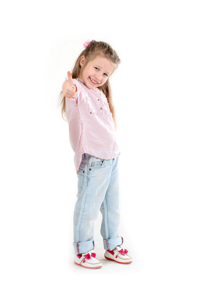the girl the blonde in a shirt and jeans on with background in studio - Foto, Bild