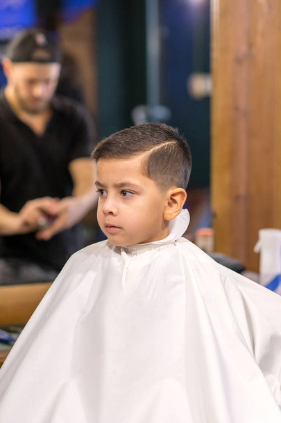 the boy is cut in hairdressing salon - Photo, Image