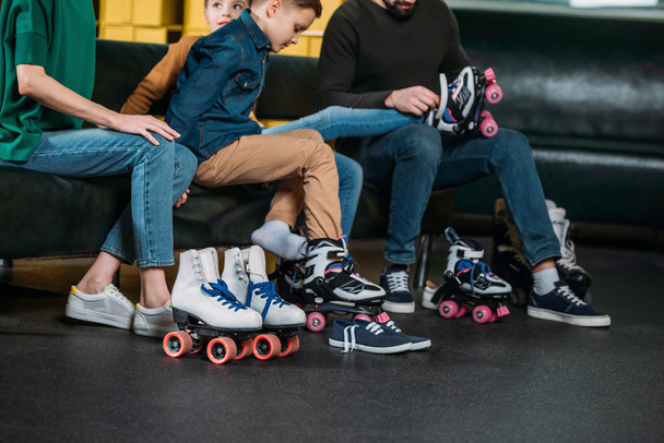 partial view of family wearing roller skates before skating in skate park - 写真・画像