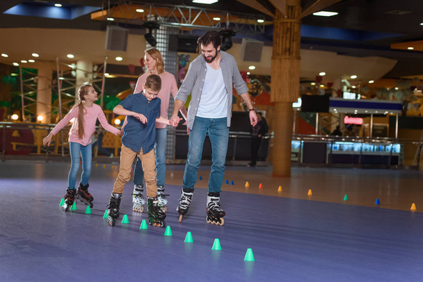 family spending time together on roller rink with cones - 写真・画像