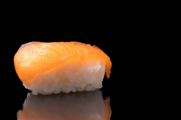 Sushi, japanese food, rice with salmon on black background. - Fotoğraf, Görsel