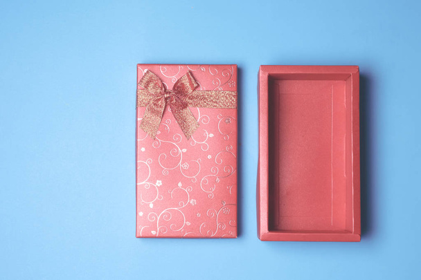 Top view of open red gift box on blue background. Free space for text - Fotografie, Obrázek