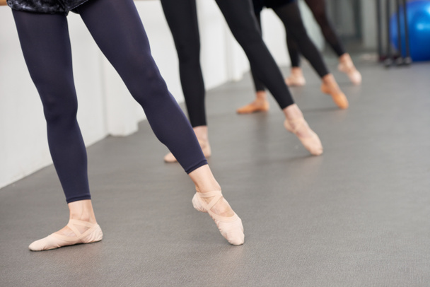 Ballerinas zeigen Zehen bei Übungen am Geländer - Foto, Bild