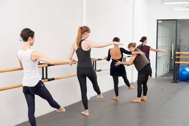 Instructor helping women to perform exercises correctly - Photo, Image