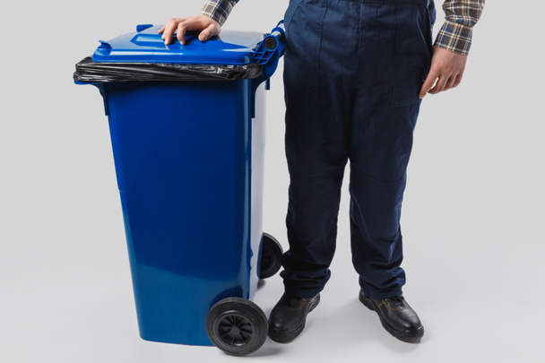 partial view of cleaner with trash bin isolated on grey - Photo, Image