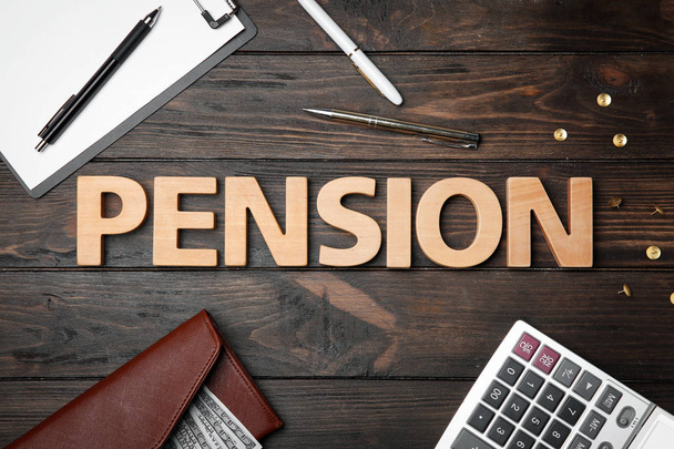 Word pension, calculator, money and pens on wooden background - Φωτογραφία, εικόνα