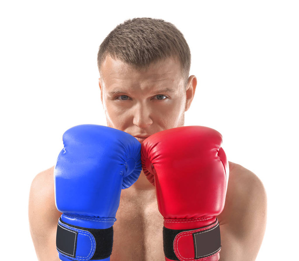 Man wearing red and blue boxing gloves on white background. Concept of political confrontation between American major parties - Democratic and Republican - Photo, Image