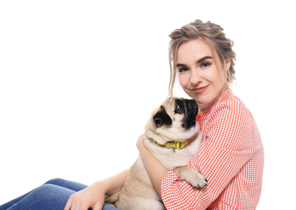 Young woman with cute pug dog on white background. Pet adoption - Valokuva, kuva