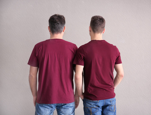 Men in color t-shirt on light background. Mockup for design - Photo, Image