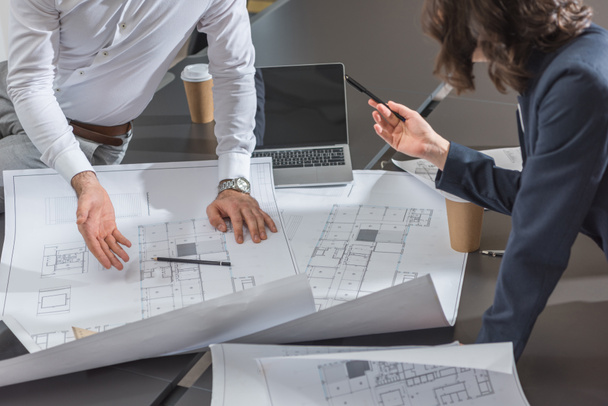 cropped shot of team of successful architects discussing building plans together  - 写真・画像