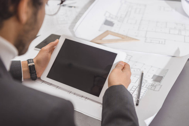 cropped shot of young architect using tablet at workplace - Photo, image