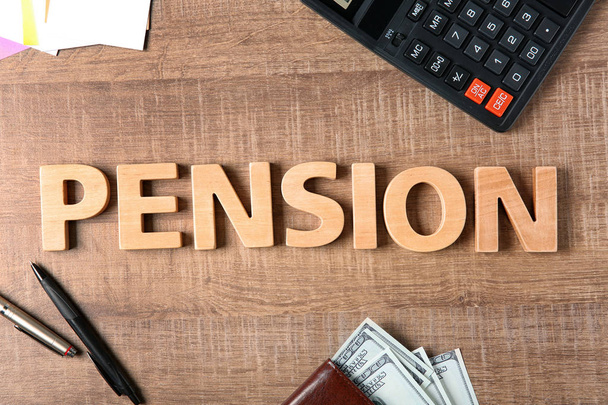 Word pension, pens, calculator and money on wooden background - Φωτογραφία, εικόνα